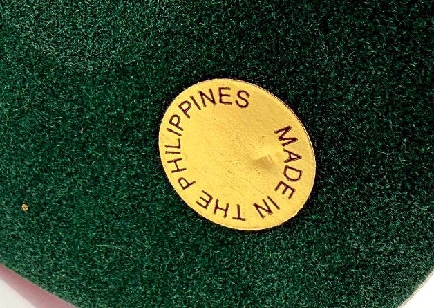 Detail crop — the gold Made in the Philippines sticker on the felt base