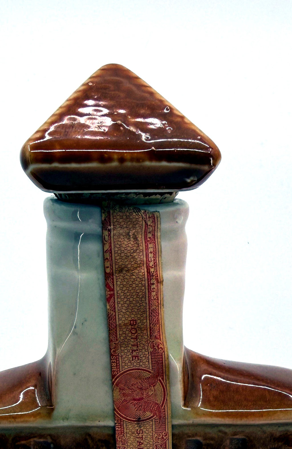 Detail crop of the ceramic roof stopper and paper federal tax strip