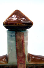 Detail crop of the ceramic roof stopper and paper federal tax strip