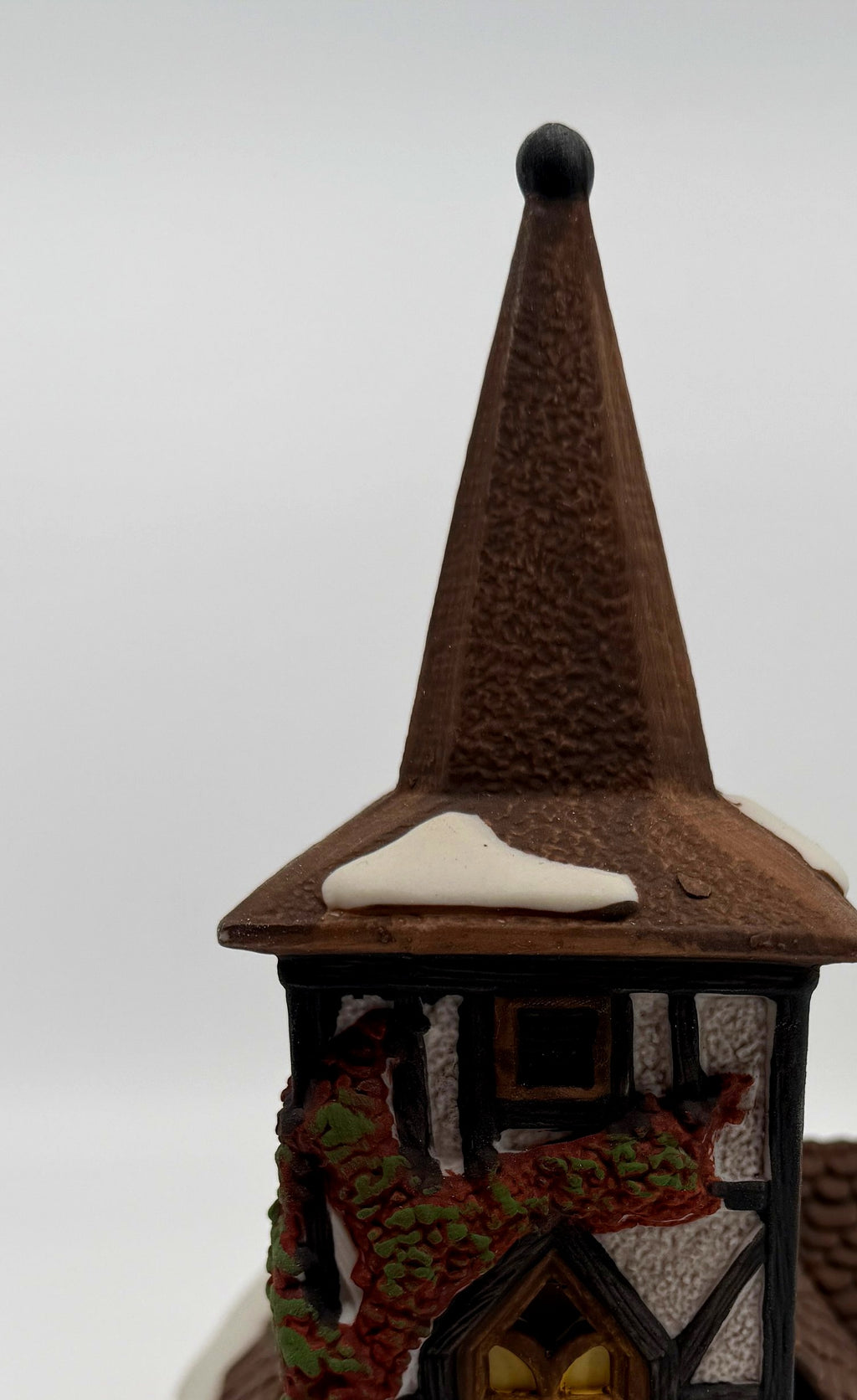 Department 56 Dickens' Village Old Michaelchurch 1992 lighted porcelain church — detail: spire, black finial and red-and-green ivy on the tower