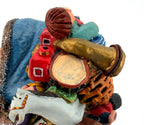 Detail crop — the toy pack’s drum, brass horn, red train and rocking horse