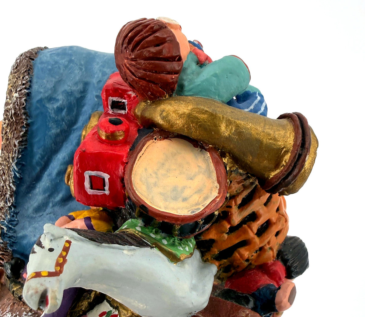 Detail crop — the toy pack’s drum, brass horn, red train and rocking horse