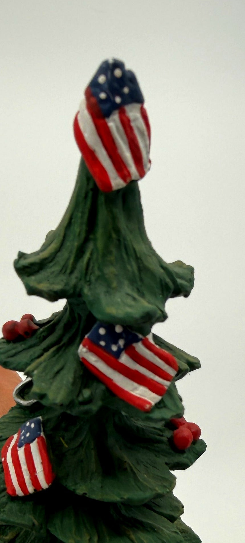 Vintage 1983 Duncan Royale Pioneer Santa figurine – detail of the Christmas tree top with hand-painted American flag ornaments and red berries