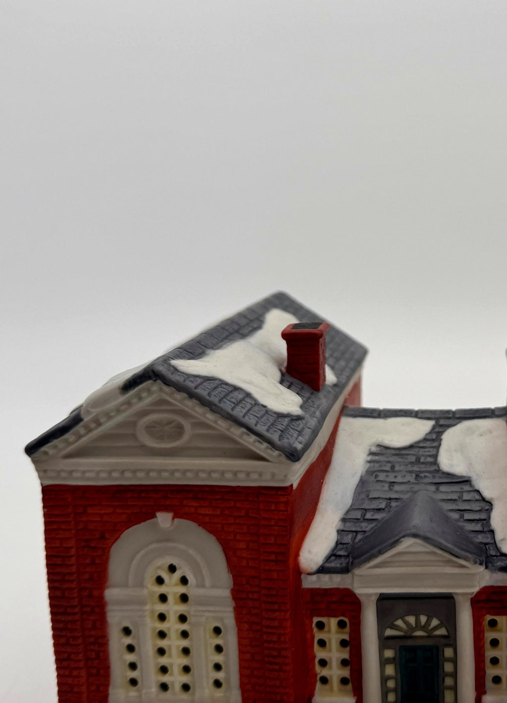 Detail of the tall arched window and pediment
