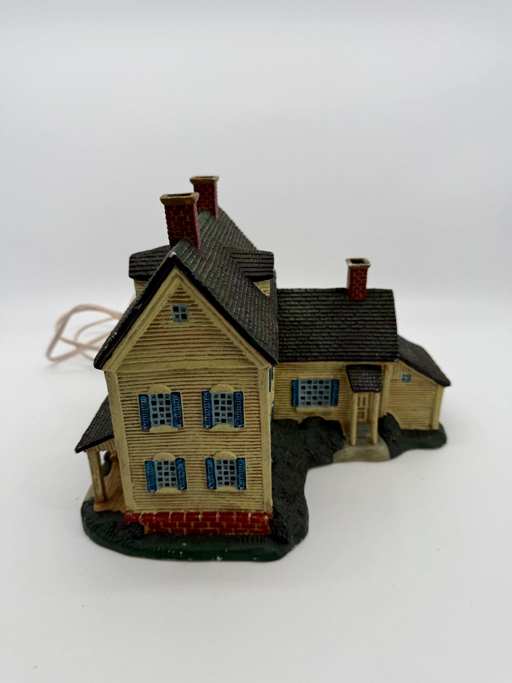 Gable end and side wing with shuttered windows and brick foundation