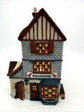 Department 56 Dickens' Village Poulterer 1988 lighted porcelain poultry shop — front view: stone poultry shop with half-timbered gable, Poulterer sign and red roosters