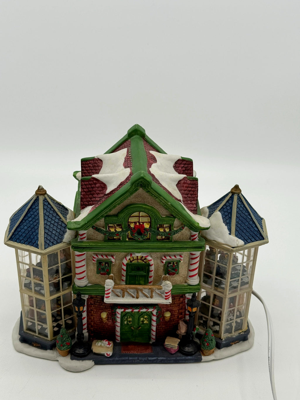 Front view of the Child's Wonder Candy Shop from a slightly high angle, showing the snow-covered roof and both glass bay towers