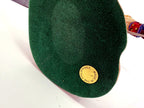 Underside of the base — green felt with the gold Made in the Philippines sticker; the original numbered label is no longer present