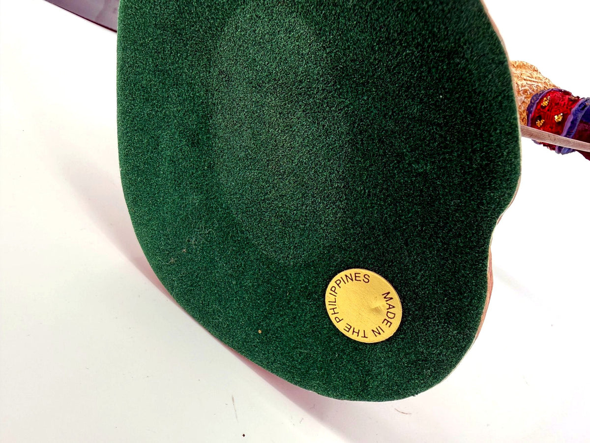 Underside of the base — green felt with the gold Made in the Philippines sticker; the original numbered label is no longer present