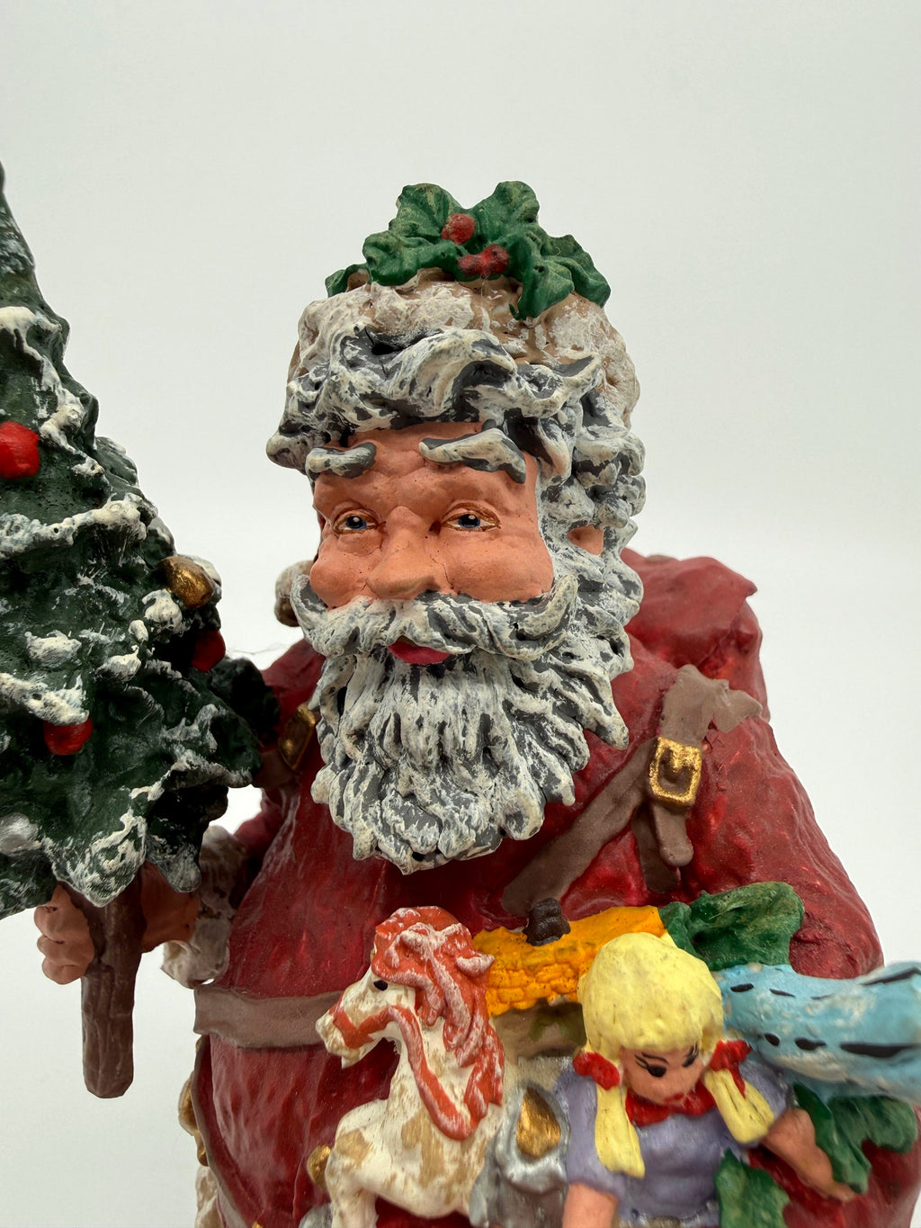 Vintage 1991 Duncan Royale Today's Nast Santa figurine – close-up of Santa's face: holly sprig on his cap and snow-flocked hair and beard