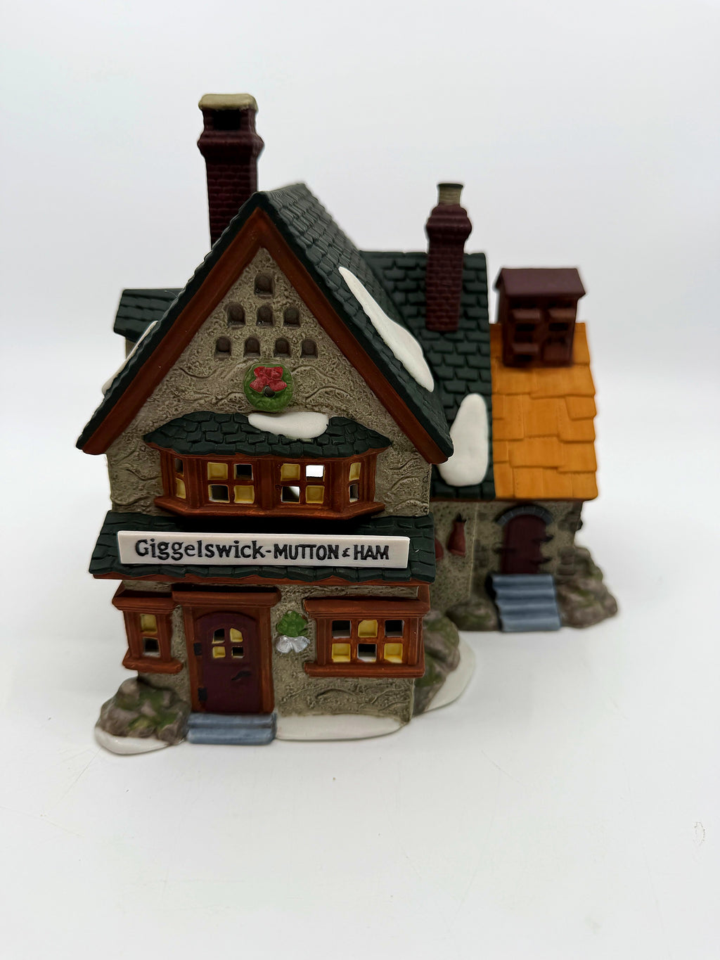 Front view of the Giggelswick Mutton & Ham butcher shop with bay window and Christmas wreath