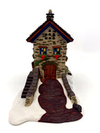 The Maltings gable end with double doors, cobbled path and broom