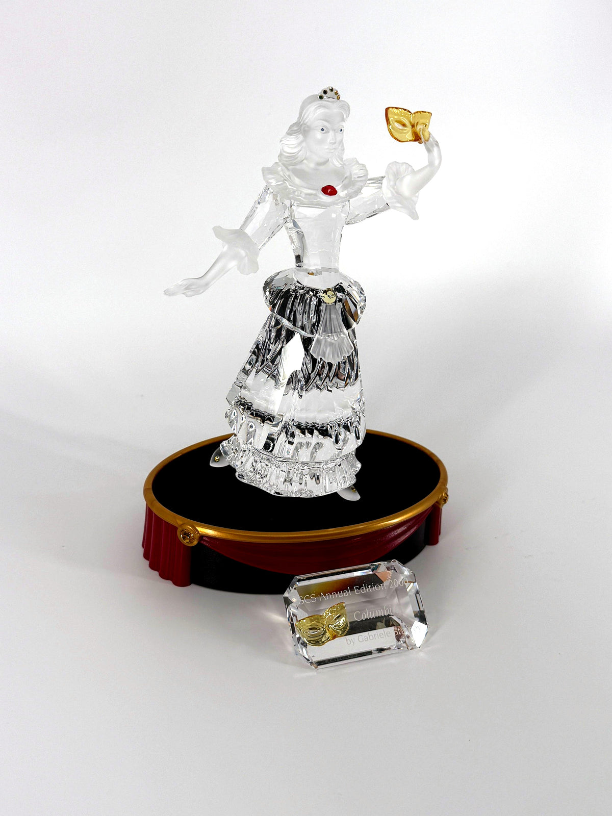 Swarovski SCS 2000 Columbine Masquerade crystal figurine — the figurine on its oval display base with the crystal title block in front