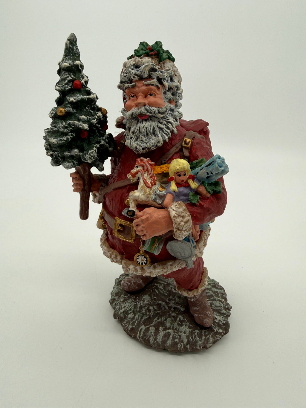 Vintage 1991 Duncan Royale Today's Nast Santa figurine – three-quarter front view showing the armful of toys and the red toy sack on his back