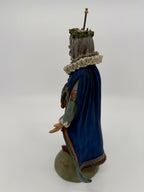 Vintage 1985 Duncan Royale Sir Christmas figurine – side-back view with staff: the deep royal blue velvet-look cape falling from the lace ruff