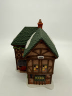 Department 56 Dickens' Village T. Puddlewick Spectacle Shop #58334 — front three-quarter view showing the 1731 plaque