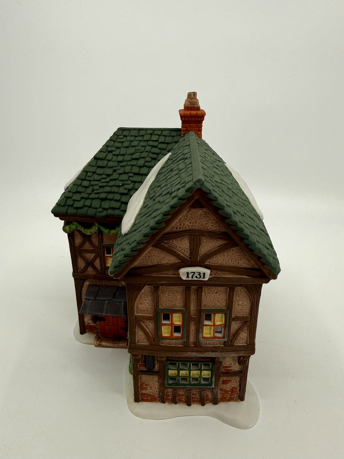 Department 56 Dickens' Village T. Puddlewick Spectacle Shop #58334 — front three-quarter view showing the 1731 plaque
