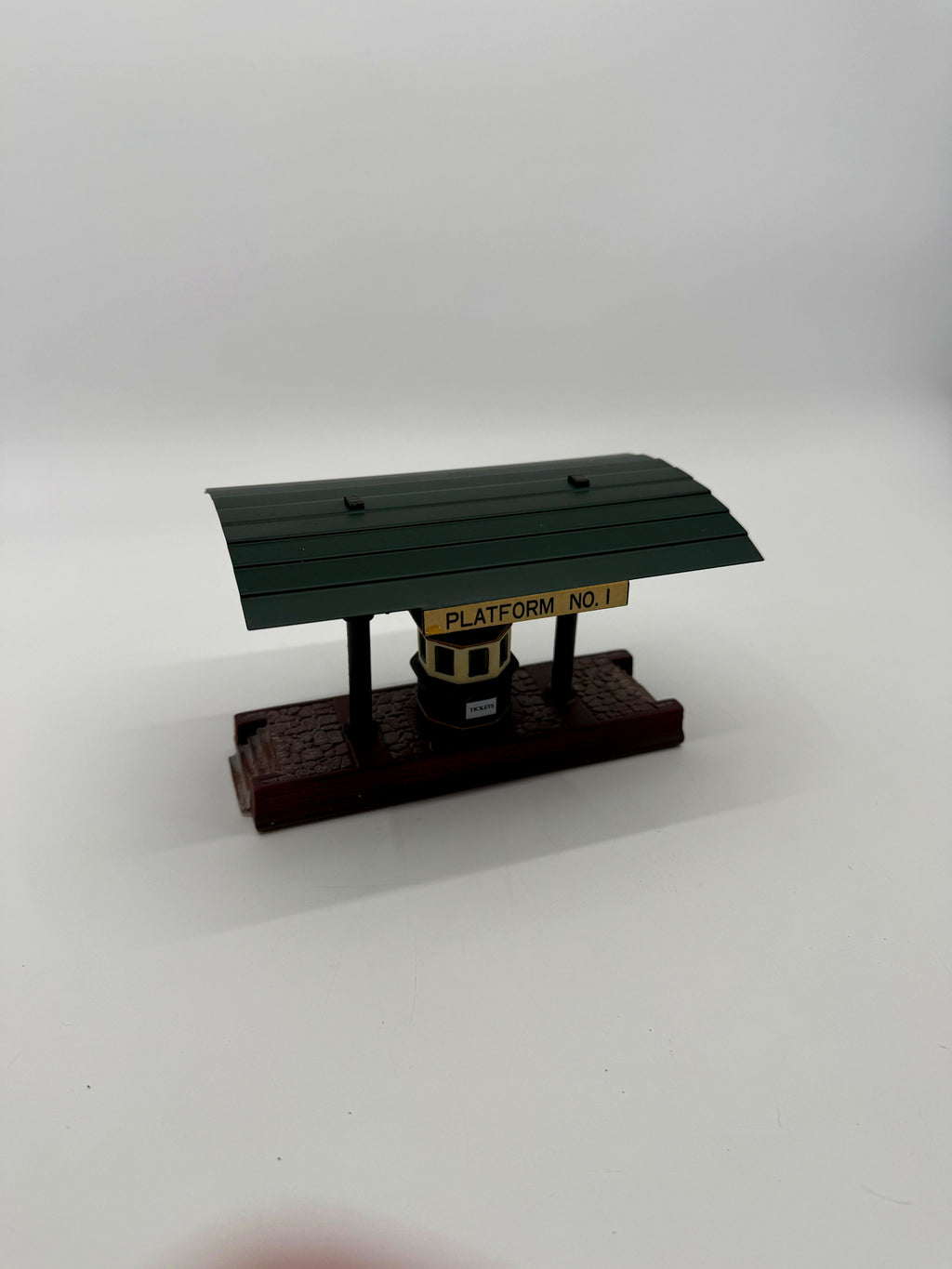 Platform No. 1 side at an angle: green canopy, posts and cobblestone base (enhanced photo)