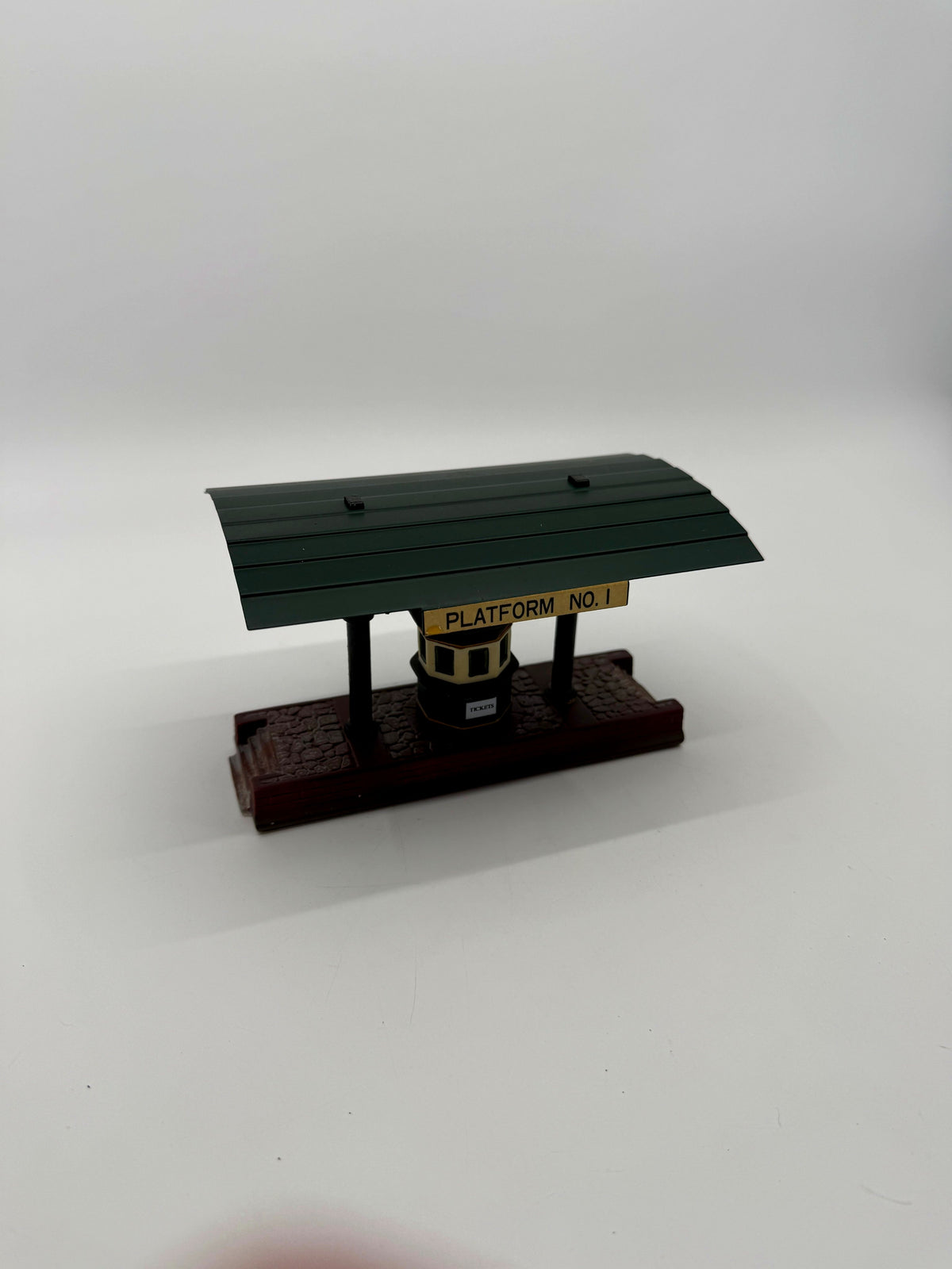 Platform No. 1 side at an angle: green canopy, posts and cobblestone base (enhanced photo)
