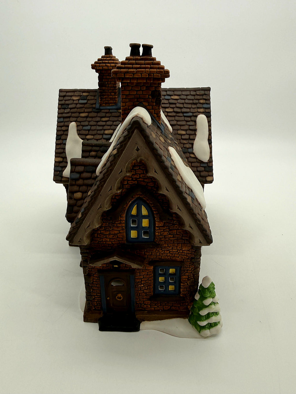 End view with the arched gable window, back door and snow-covered pine