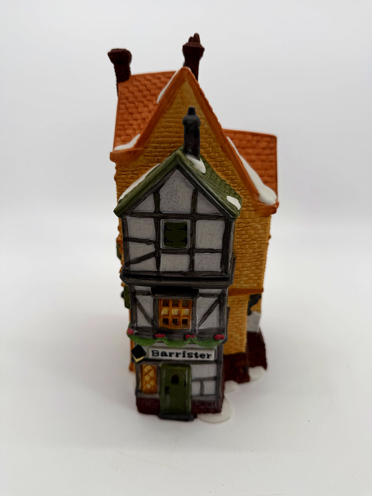 Barrister Tudor wing side view with snow-dusted half-timbered gable and green shutters