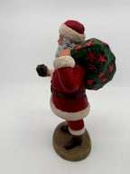 Vintage 1994 Duncan Royale Santa's Gift figurine – three-quarter back view showing the poinsettia gift sack