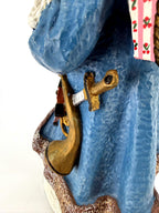 Close-up of the brass horn and lantern hanging at Santa’s hip