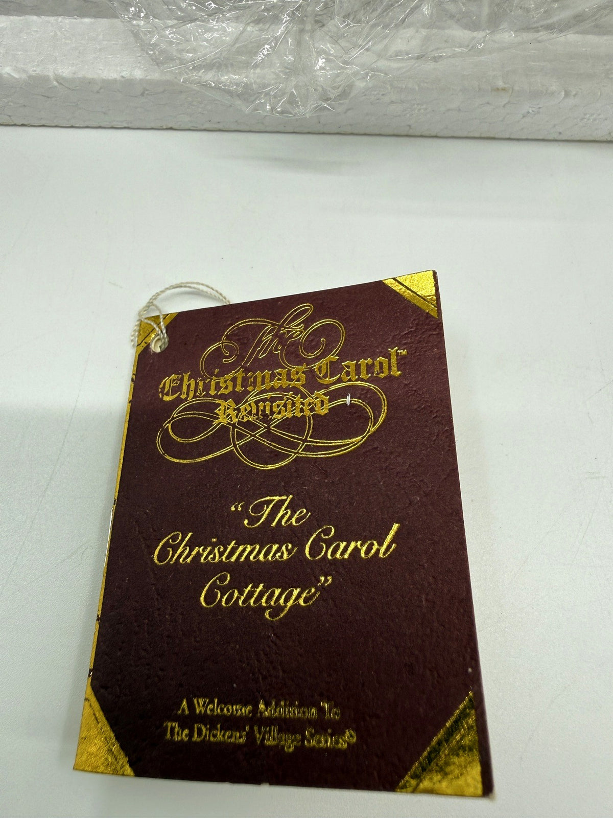 Department 56 Dickens' Village The Christmas Carol Cottage #58339 — the original Christmas Carol Revisited hangtag for The Christmas Carol Cottage