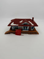Department 56 New England Village Weston Train Station #5931-5 — front view with the original red New England Village hangtag and light cord