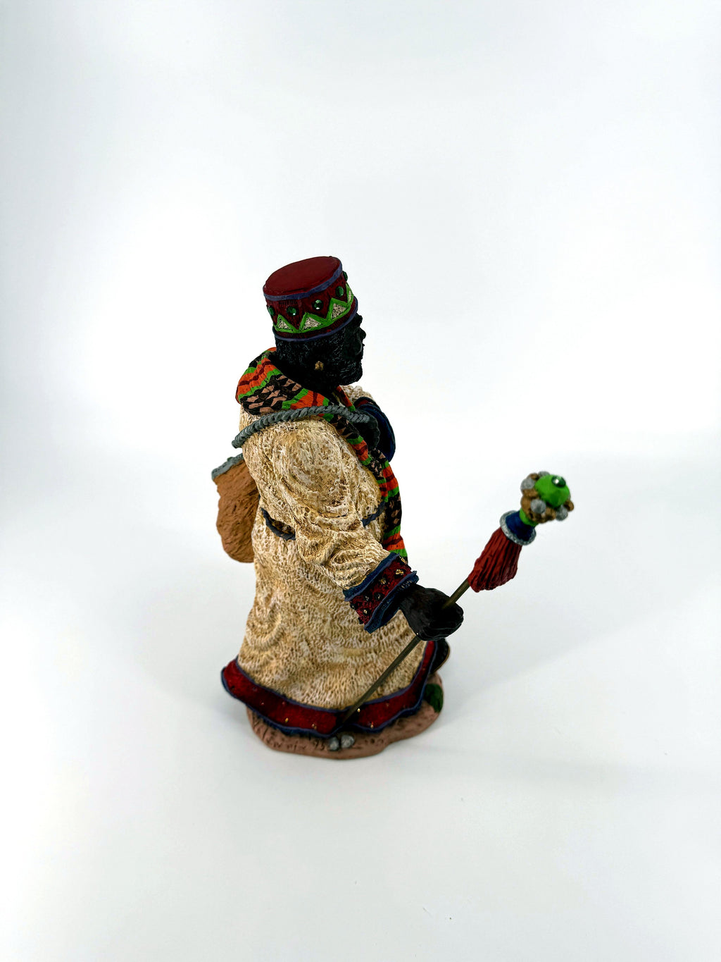 Right side view — cream textured robe, staff, and the sack carried on the shoulder strap