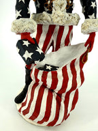Duncan Royale Civil War Santa - lower detail of the striped trousers, black boot and the oversized stars-and-stripes toy sack