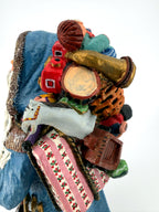 Close-up of the toy pack — rocking horse, drum, red toy train, dolls and wrapped gifts