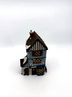 Department 56 Dickens' Village Poulterer 1988 lighted porcelain poultry shop — front three-quarter view