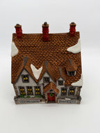 Front angle - snow-dusted shingled roof and three red chimneys