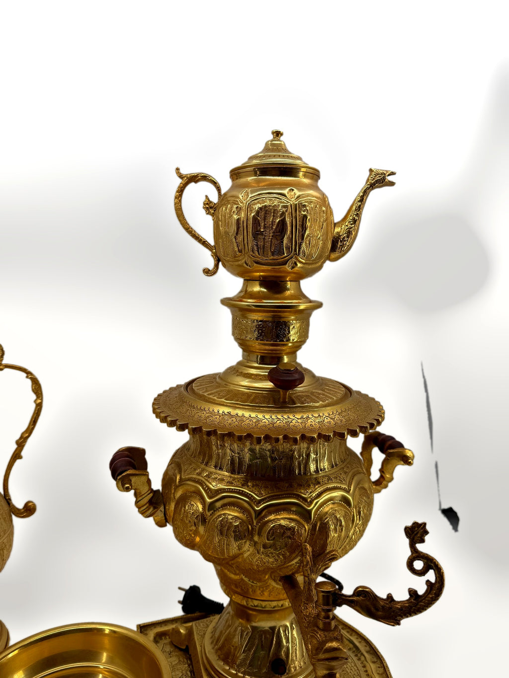 Samovar close-up – front view with teapot atop, figural spigot and engraved panels