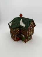Department 56 Dickens' Village T. Puddlewick Spectacle Shop #58334 — three-quarter view of the side and front