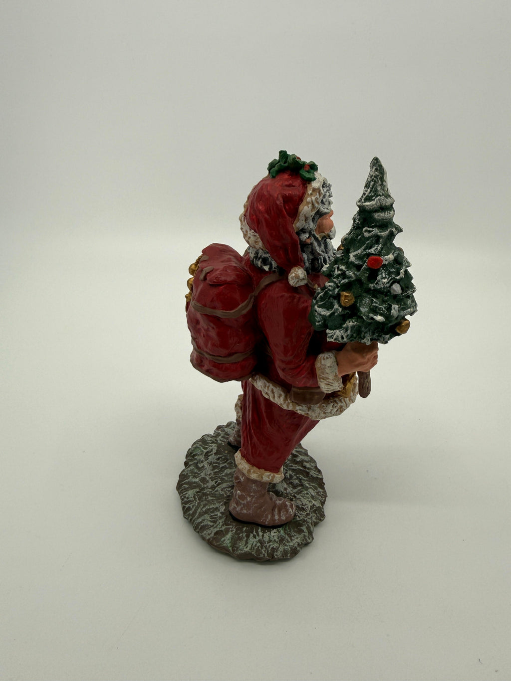 Vintage 1991 Duncan Royale Today's Nast Santa figurine – side profile view with the snow-flocked Christmas tree