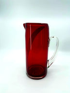Vintage ruby red glass pitcher with white swirl, 10.5 inch — back view with the clear handle at right