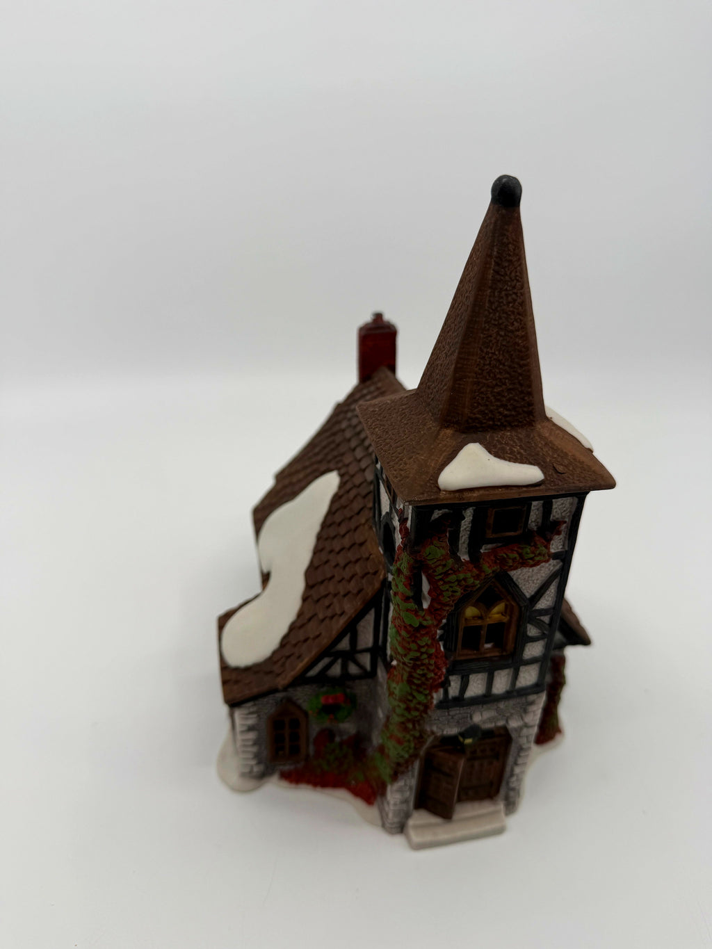 Department 56 Dickens' Village Old Michaelchurch 1992 lighted porcelain church — high-angle front view showing snow-dusted shingle roofs