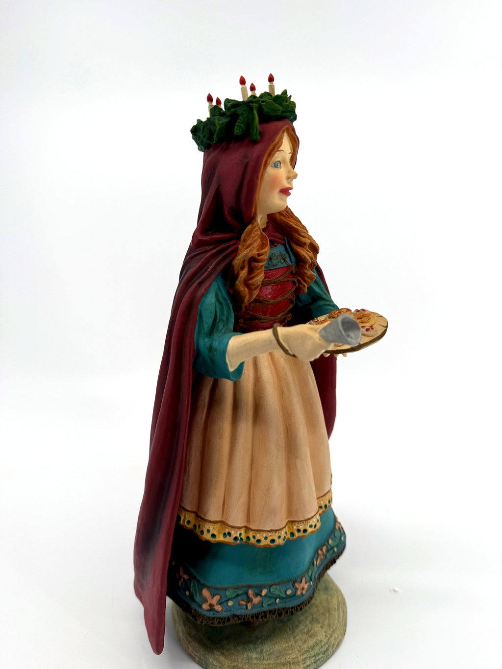 Side profile view — burgundy cloak, tray and bell