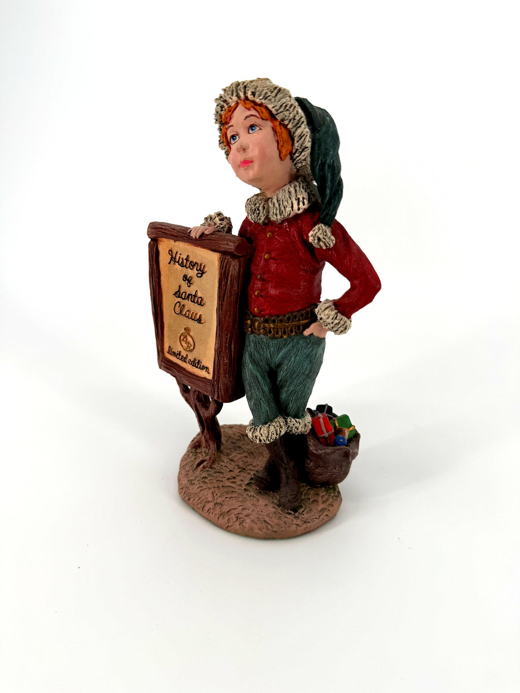 Duncan Royale History of Santa Claus Signature Piece - three-quarter view showing the sign lettering, the helper's red jacket, green trousers and the toy sack
