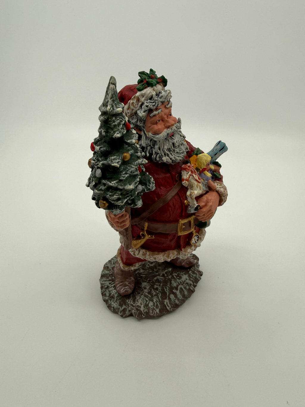 Vintage 1991 Duncan Royale Today's Nast Santa figurine – front-side view: rocking horse, doll and toy train carried in his arm, pocket watch at his belt