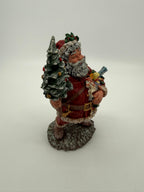 Vintage 1991 Duncan Royale Today's Nast Santa figurine – front-side view: rocking horse, doll and toy train carried in his arm, pocket watch at his belt
