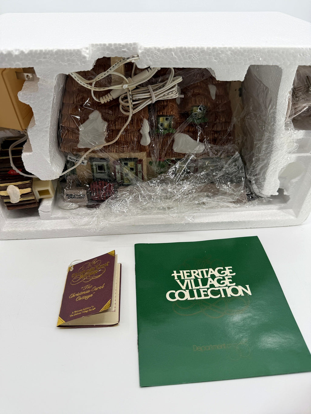Department 56 Dickens' Village The Christmas Carol Cottage #58339 — the actual item for sale: cottage still sealed in its original Styrofoam packaging, with hangtag and Heritage Village booklet