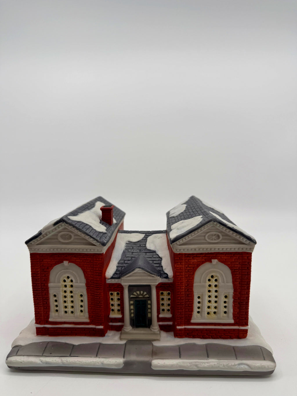 Front view close showing the columned entrance portico and arched windows