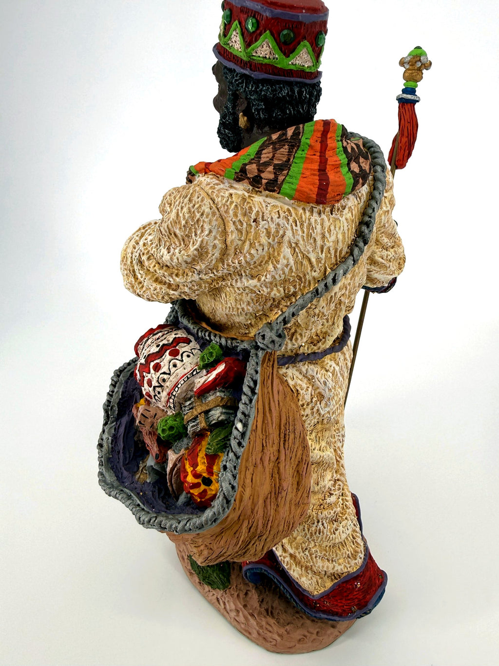 Back close view of the woven sack with its patterned drum and gifts