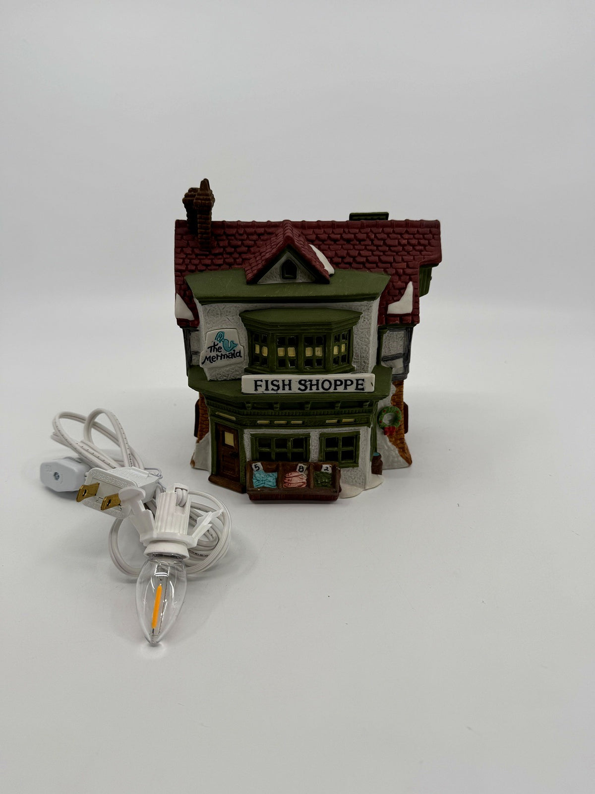 Department 56 Dickens' Village The Mermaid Fish Shoppe #5926-9 — front view with the new replacement light cord and LED bulb