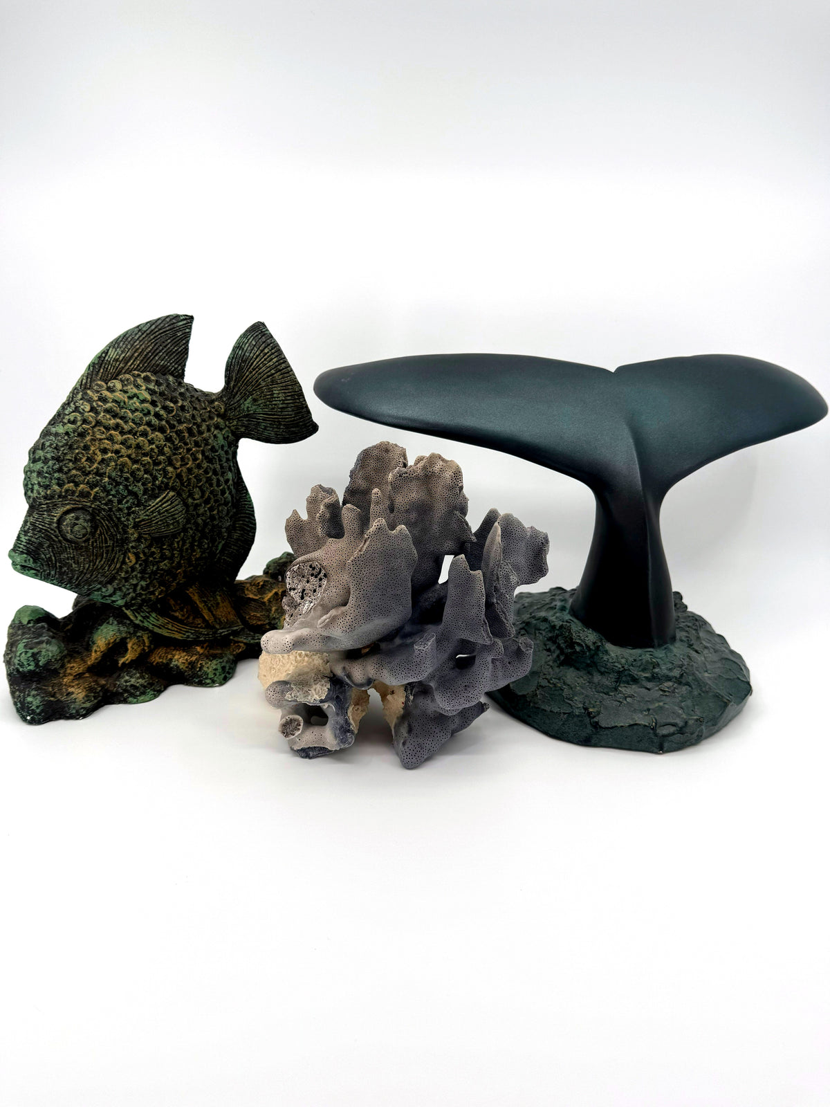 Blue coral specimen on natural base, coastal decor — styled between a fish figurine and a whale tail sculpture for scale — props not included