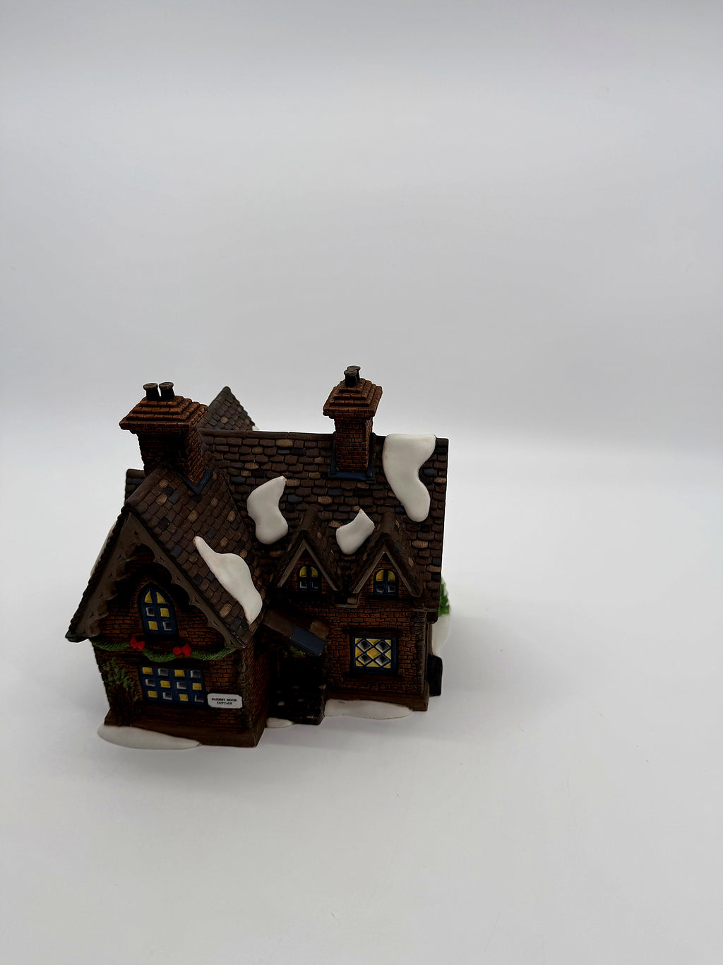 Front view from above showing the snow-dusted shingled roof and twin chimneys
