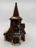 Department 56 Dickens' Village Old Michaelchurch 1992 lighted porcelain church — front view: stone-and-timber church with tall spire tower